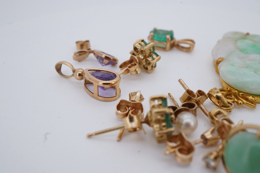 A collection of earrings and two pendants, comprising: two pairs and one single diamond studs, each set with a brilliant-cut diamond weighing approximately 0.07 carats; a pair of emerald and diamond cluster stud earrings